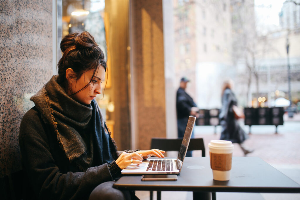 Woman working from her laptop in a coffee shop