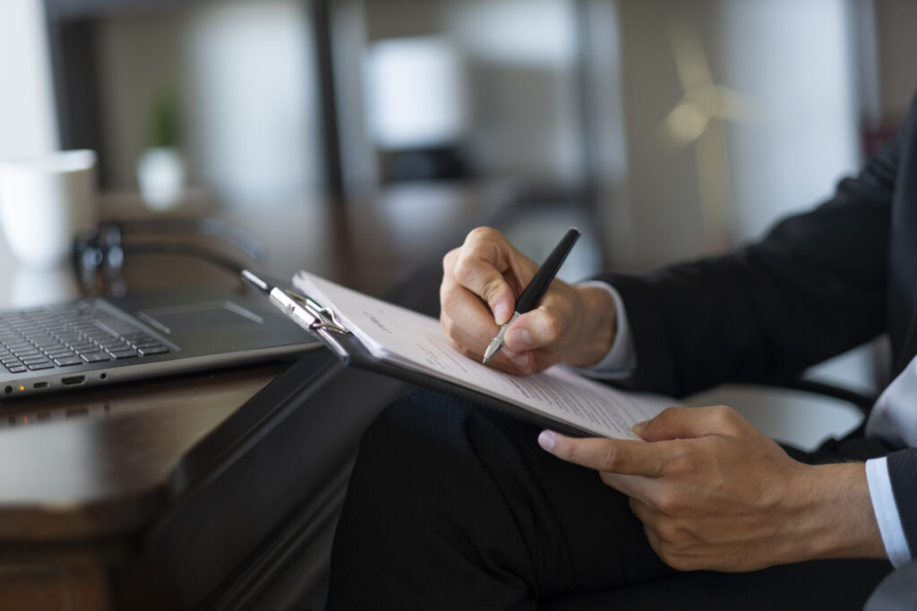 Professional signing a contract while selecting a coworking membership